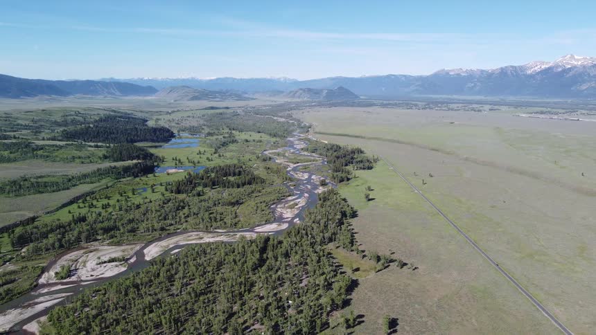 The landscape is covered with flat land that leads to a mountain range