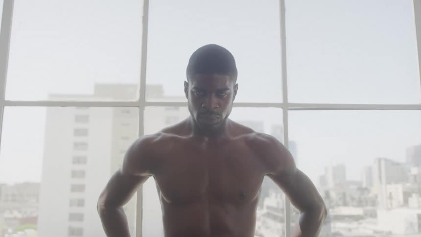 A man is angry standing in front of the window