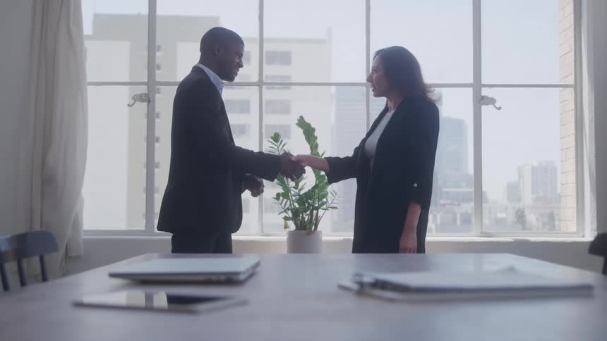 A footage of a man and a woman having an handshake in the office