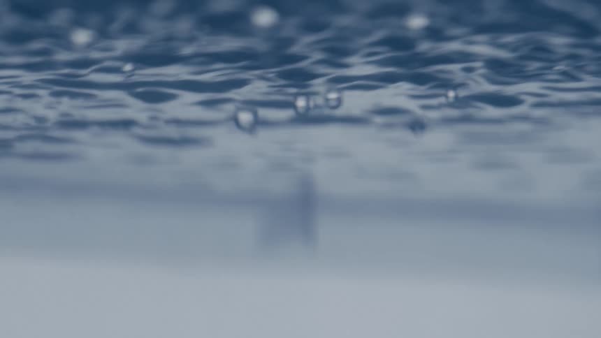 Close up of rain drops falling on water during a storm