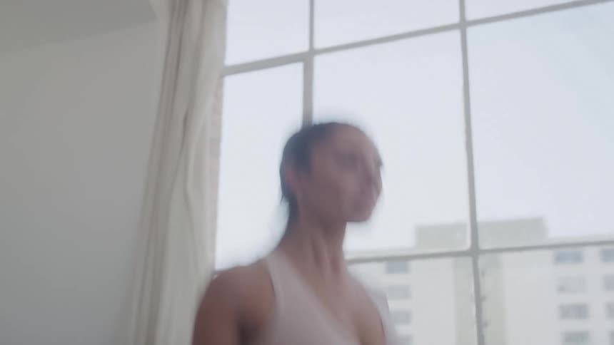 A young woman skipping rope in the gym room at midday