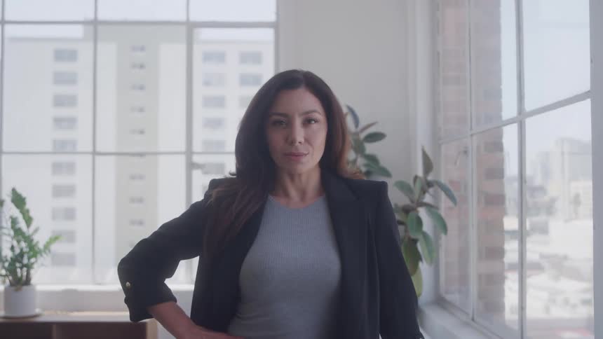 Woman with black blazer and an interior space