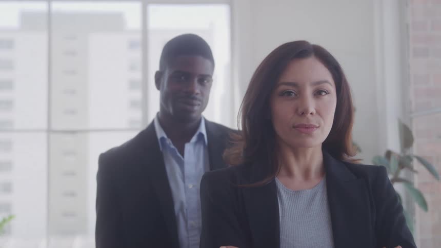 Man and woman with black blazer in an office