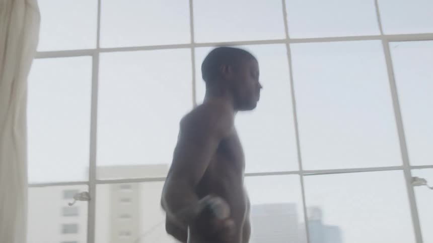 A man is jumping rope at home