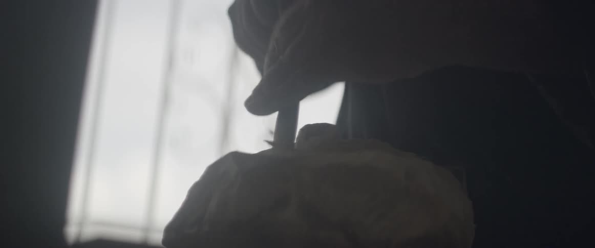 A man chips away at a chunk of wood