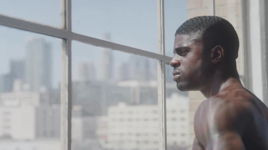 The man looks out the window over the big city