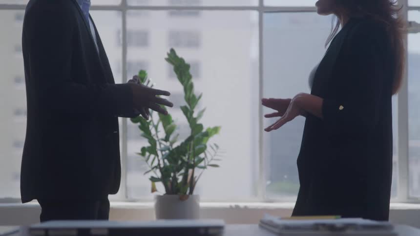Two people talking in an office environment