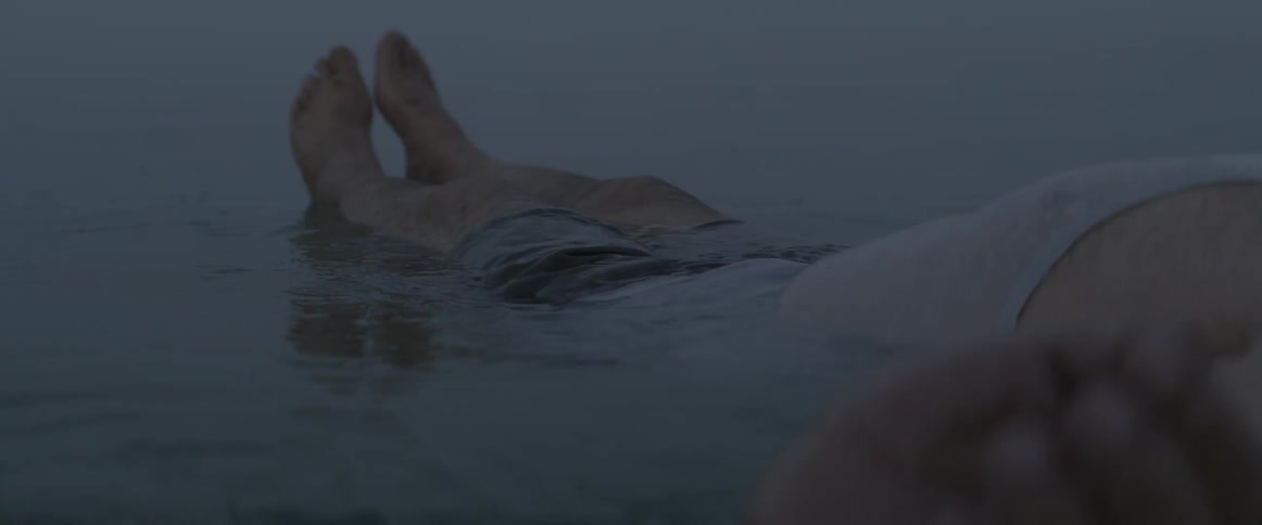 A man floats in the water on his back