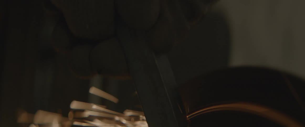 Someone sharpens metal against a wheel