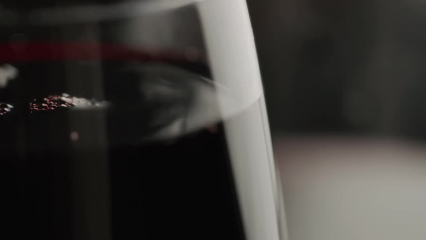 Extreme close up of red wine being poured into a wine glass