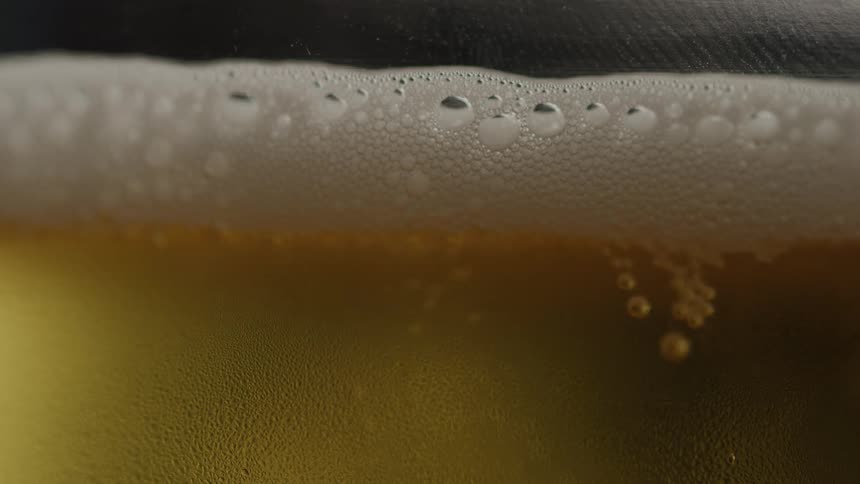 The bubbles float to the surface of the beer