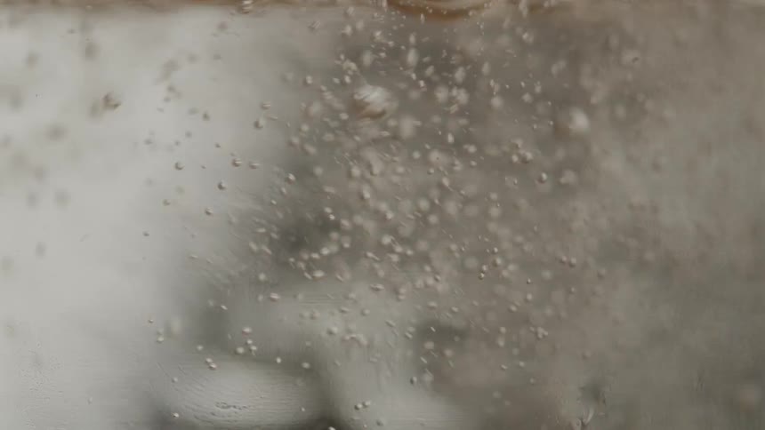 The water in the glass is boiling