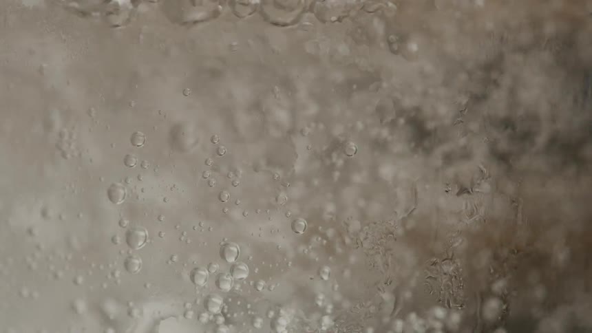 The glass is filled with a fizzy drink
