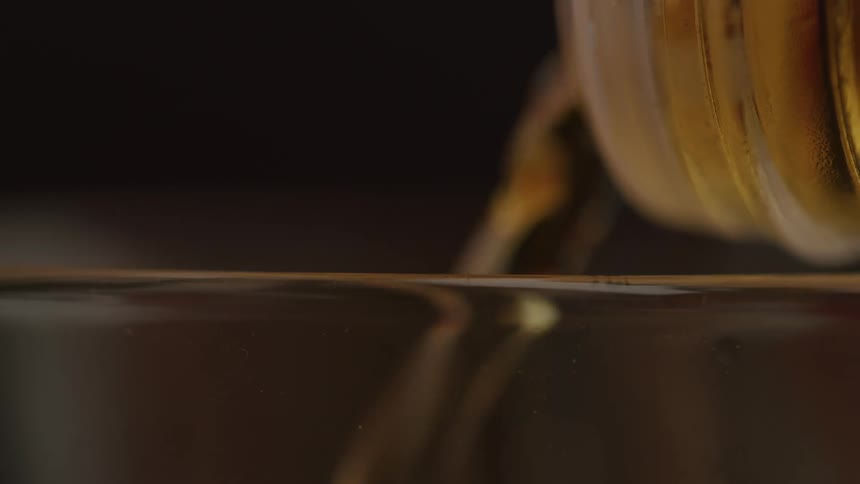 Alcohol is poured into the glass