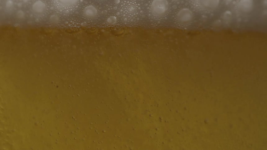 Glass cup being filled with beer