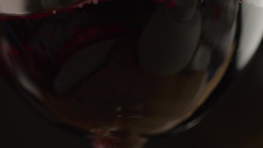 The red wine stirs around as it is poured