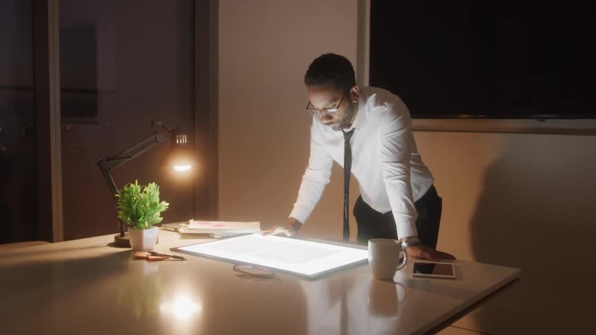 A man reads something on a large tablet