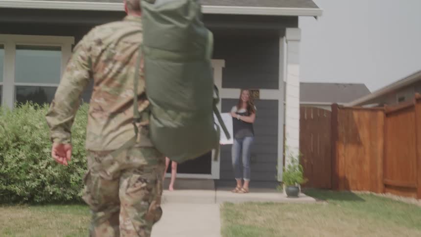 The soldier runs over to his family