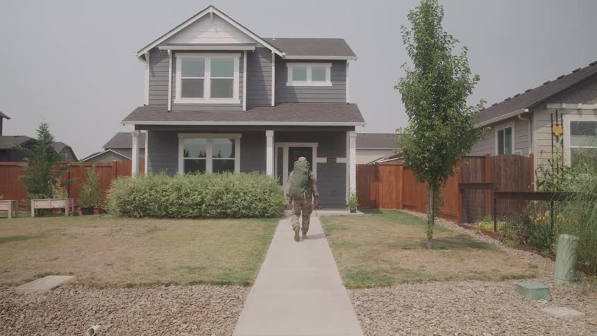 The soldier walks to his home