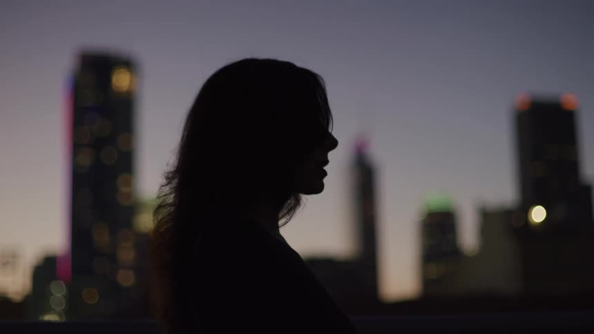 A woman raises her head and looks in the distance