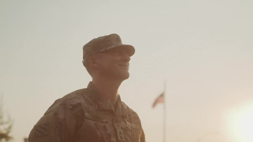 The soldier is smiling in uniform