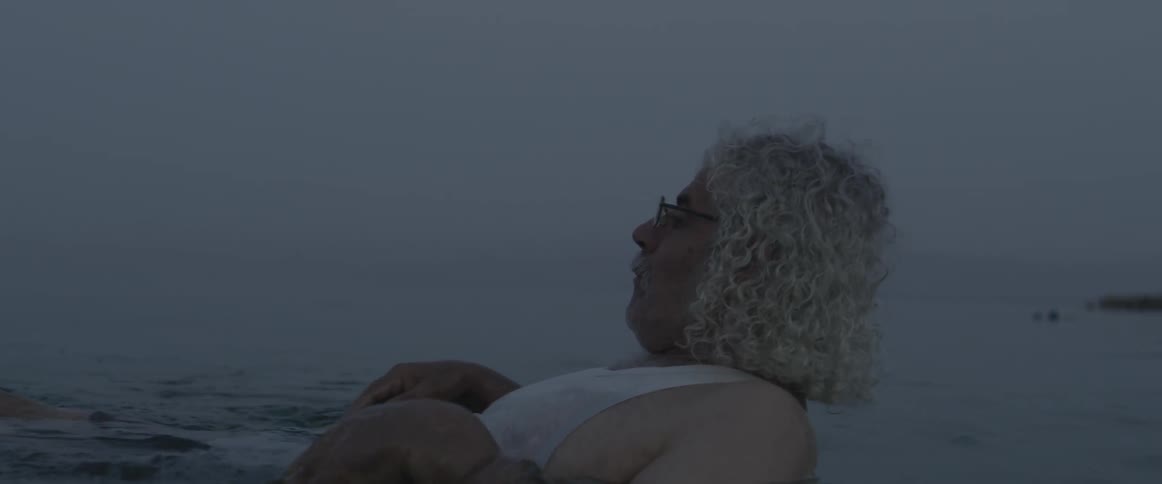 A man is lying in the water relaxing