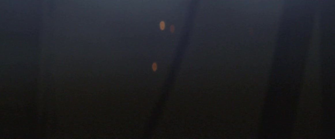 Sparks fall in a flickering dark room