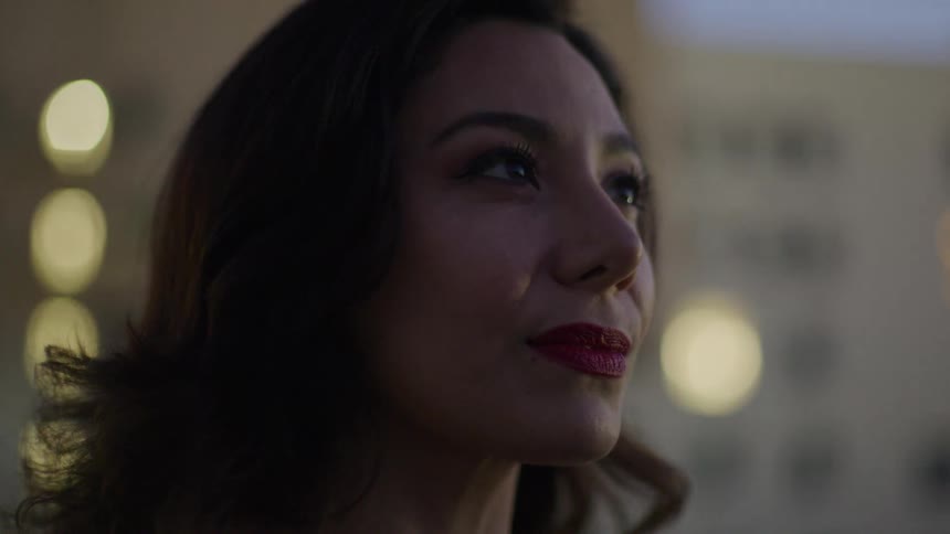 A woman is looking around at the buildings