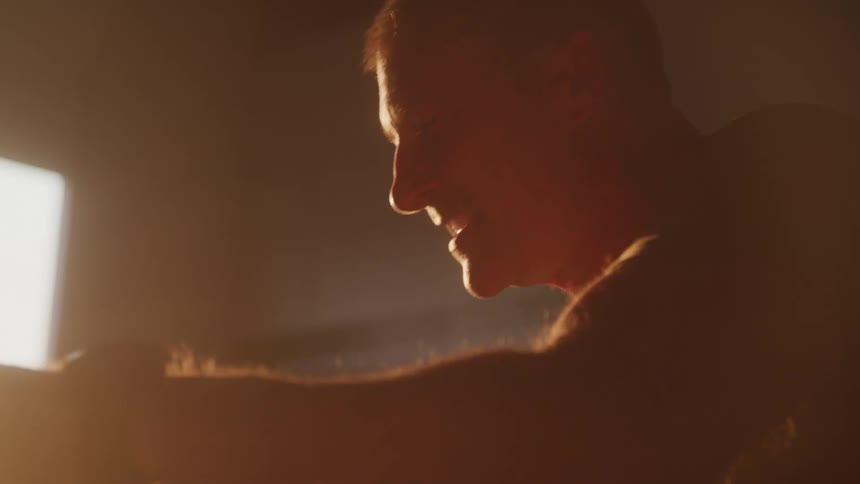 A man is punching forward in the gym