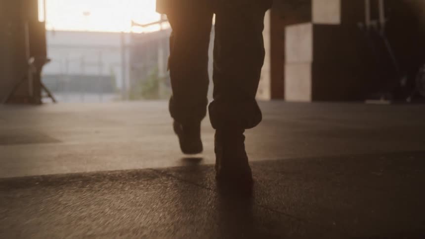 The soldier is walking out of the room