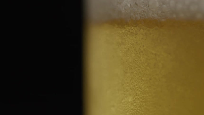 Close up pouring beer into a glass lager
