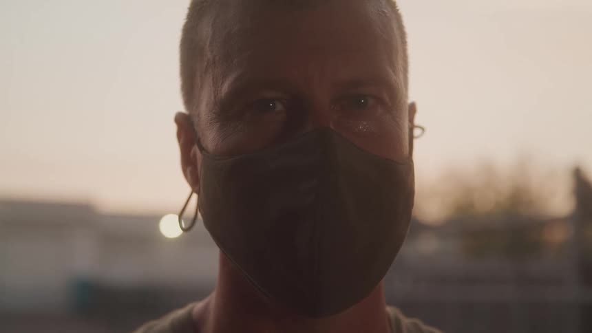 A man is wearing a mask over his mouth and nose