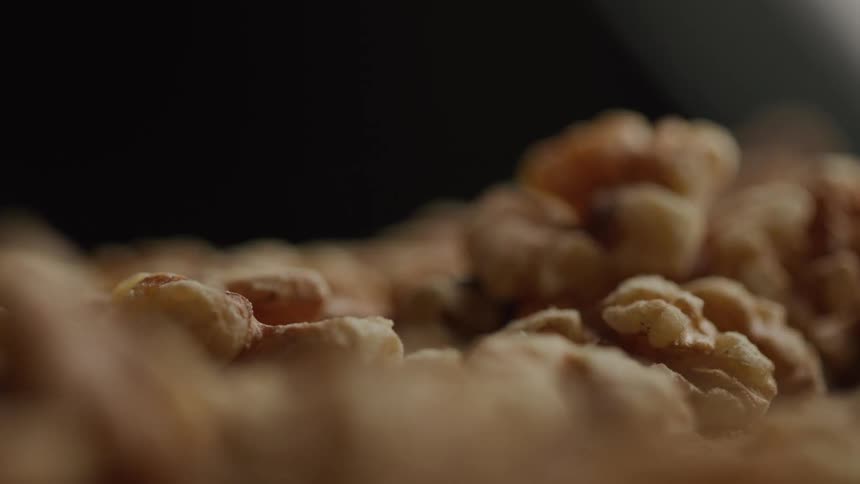 A closeup of several walnut halves in soft warm lighting