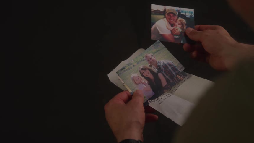 A man is looking at photos of people