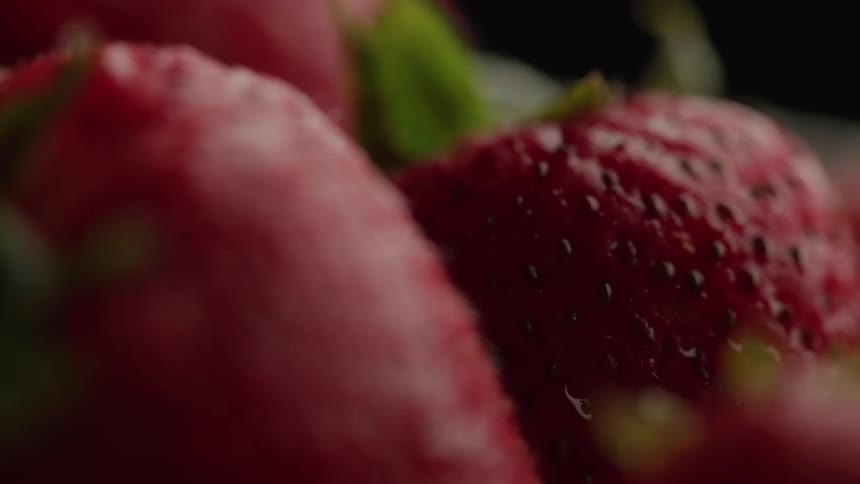 A small bunch of strawberries are shown very close up