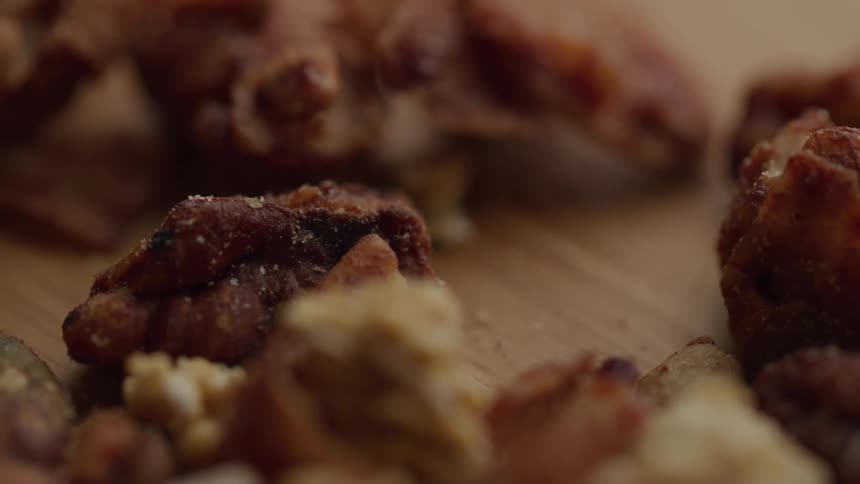 Walnuts and almonds on a wooden surface