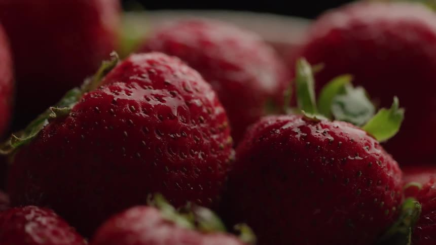 Close up fresh ripe strawberries in a white bowl