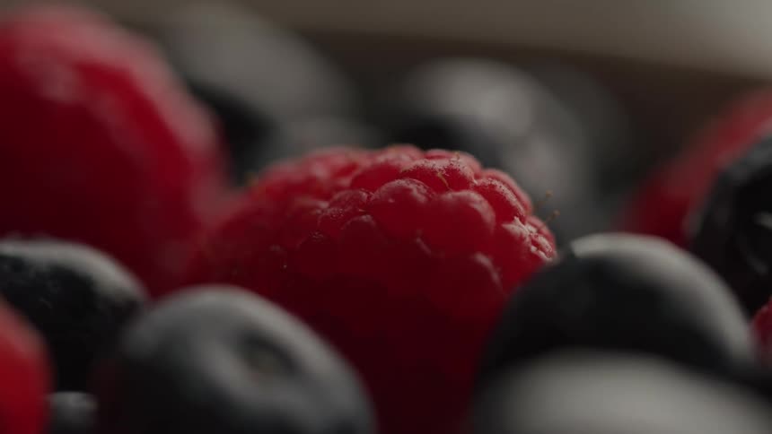Fresh ripe raspberry mixed with blue berries in a bowl
