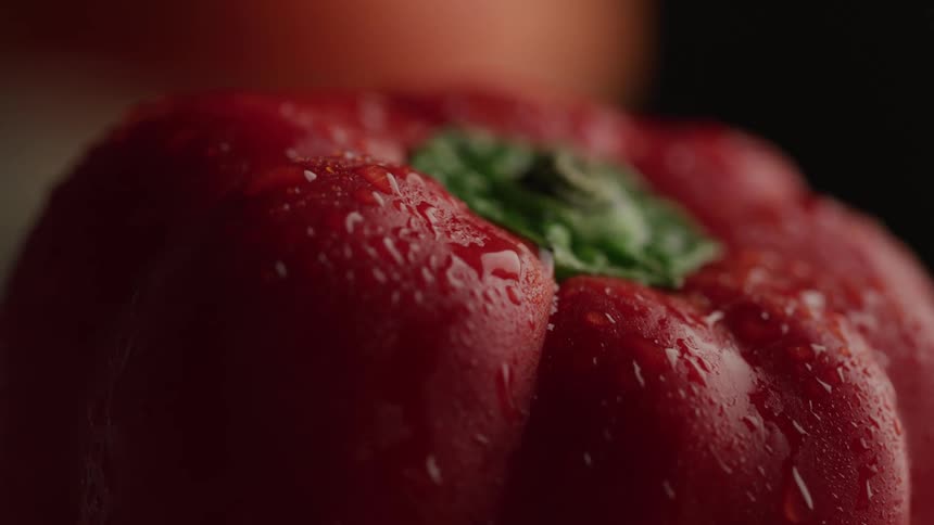 Close up water droplets on a ripe red bell pepper