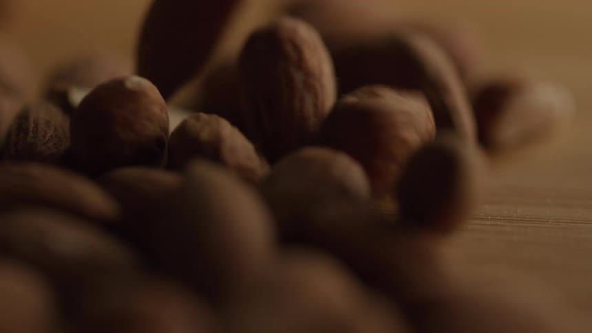 A pile of almonds fall and bounce