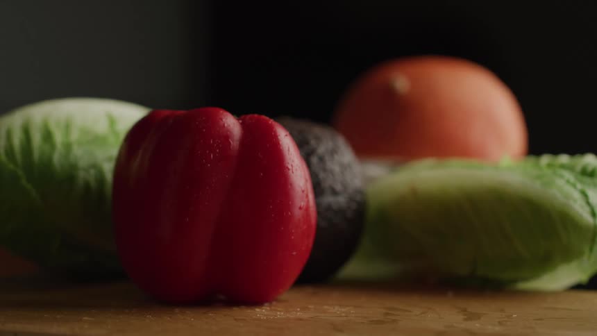 A pepper is put down with other vegetables