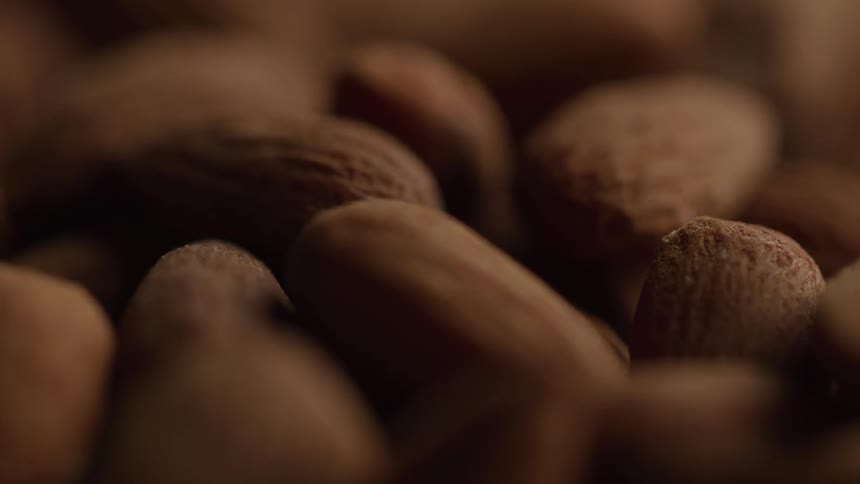 A series of nuts stacked on a surface at midday