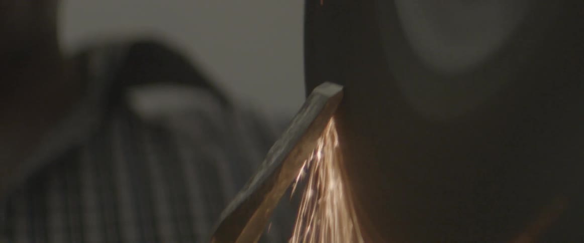 Sparks fly off of a grinding wheel