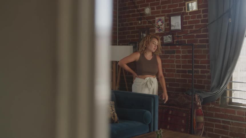 A footage of a lady walking in a room