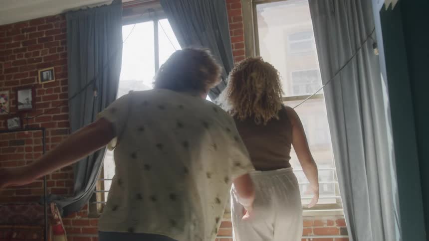 Man and woman arguing in a bedroom