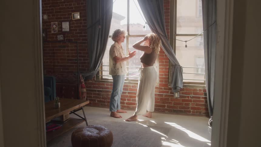 A couple is arguing in a sunlit apartment living room