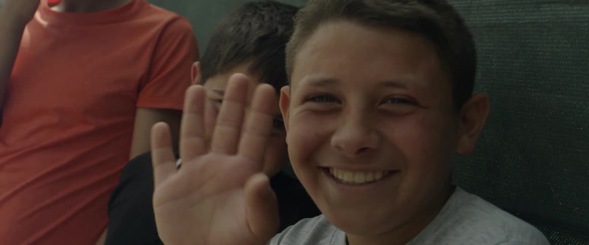 Children wave and smile