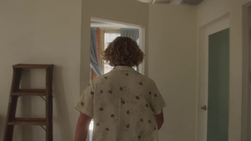 Man walking through the room of the house