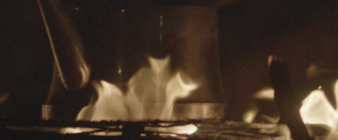 The fire rises around the tin pot on a fire