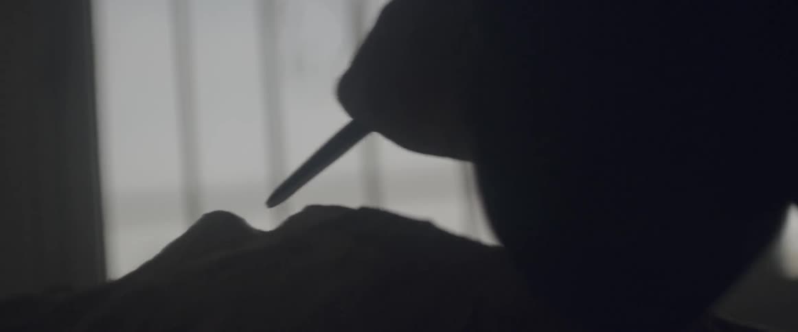A man uses chisel to shape a stone
